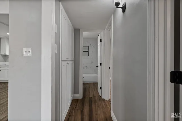 an empty room with a window and a ceiling fan