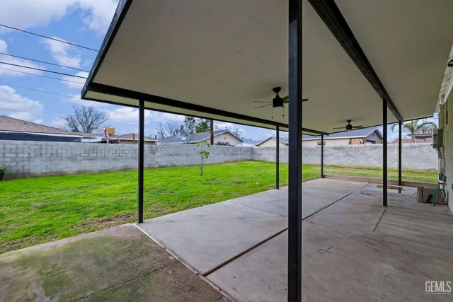 a view of a house with a big yard plants and large trees