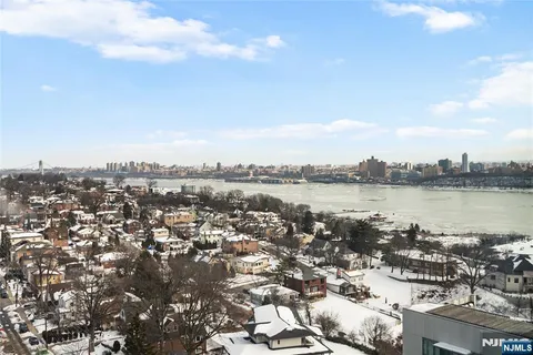 a living room with furniture a table and kitchen view