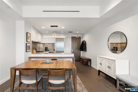 a kitchen with a table chairs sink and microwave