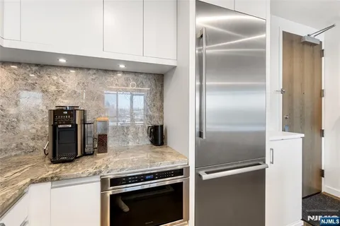 a kitchen with granite countertop stainless steel appliances and a counter top