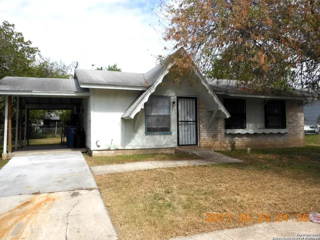 a front view of a house with a garden and yard
