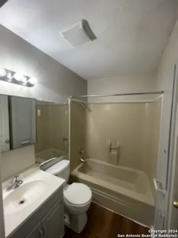 a bathroom with a sink toilet a mirror and shower