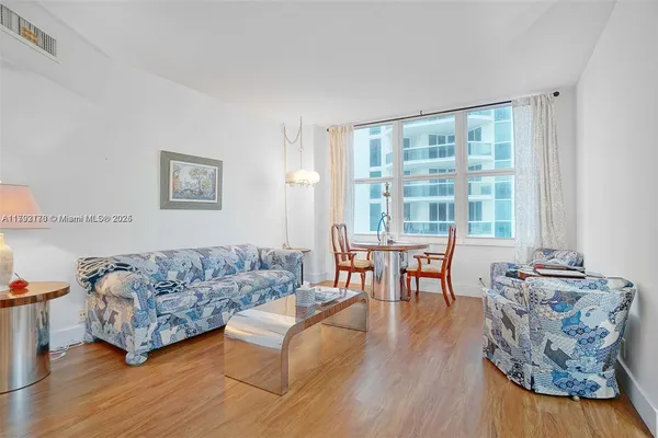 a living room with furniture and a large window