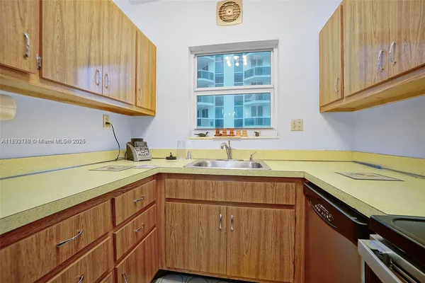 a kitchen with a sink cabinets and window