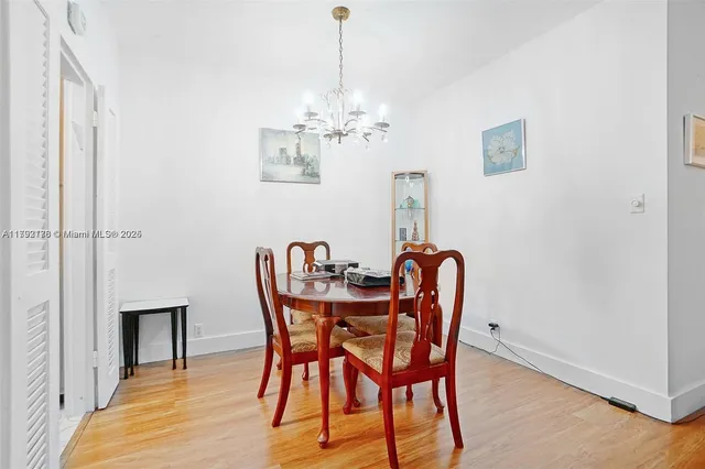 a dining room with furniture and chandelier