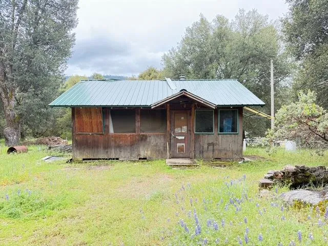 a front view of a house with yard and trees
