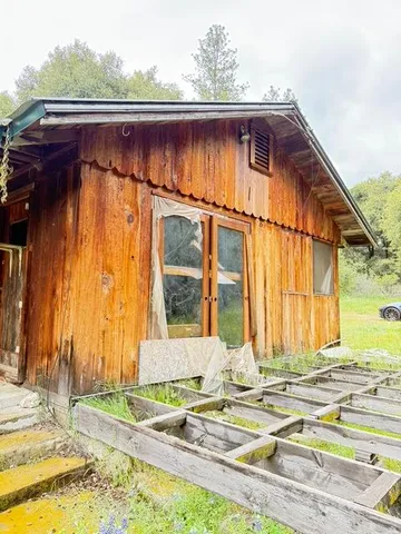 a view of a house with a yard and sitting area