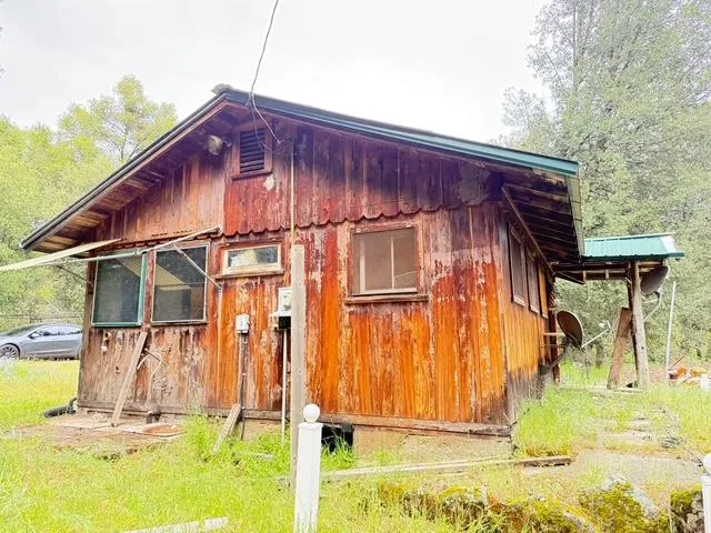 a view of a house with a wooden fence