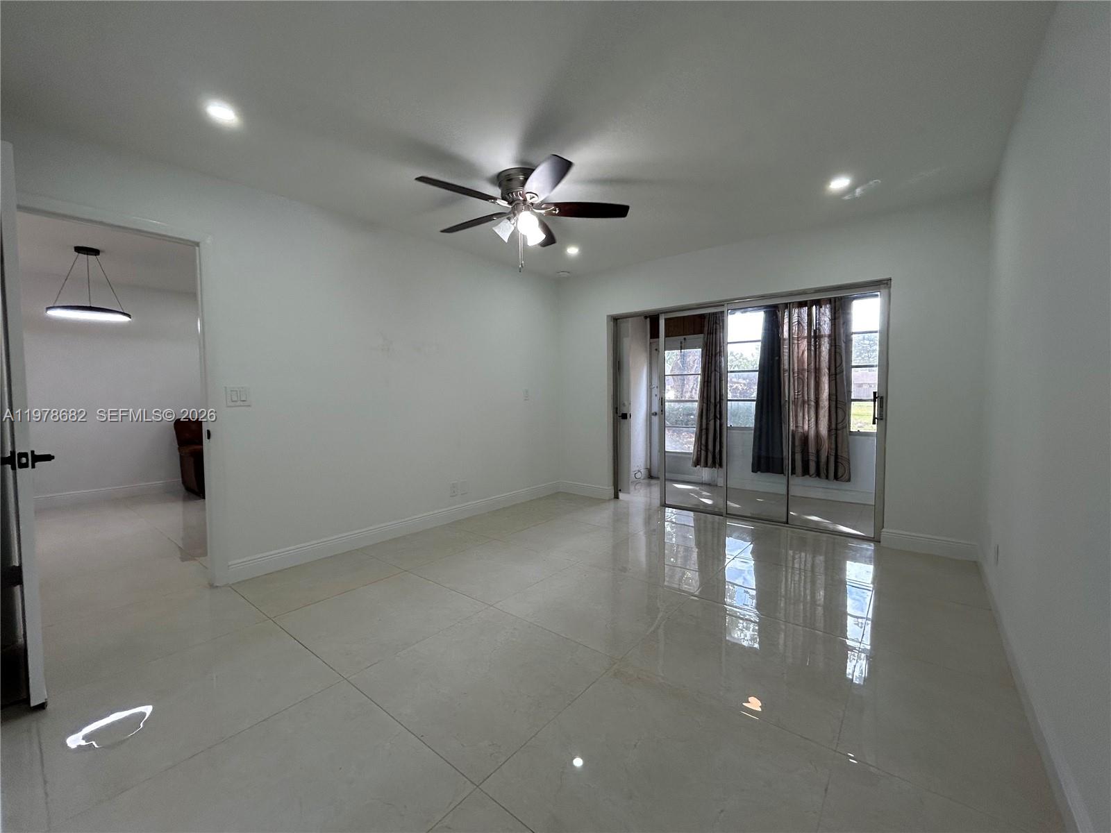 300 Berkley Road, Unit 108 Hollywood, FL 33024 - Photo 19 of 41 a view of empty room with wooden floor and fan
