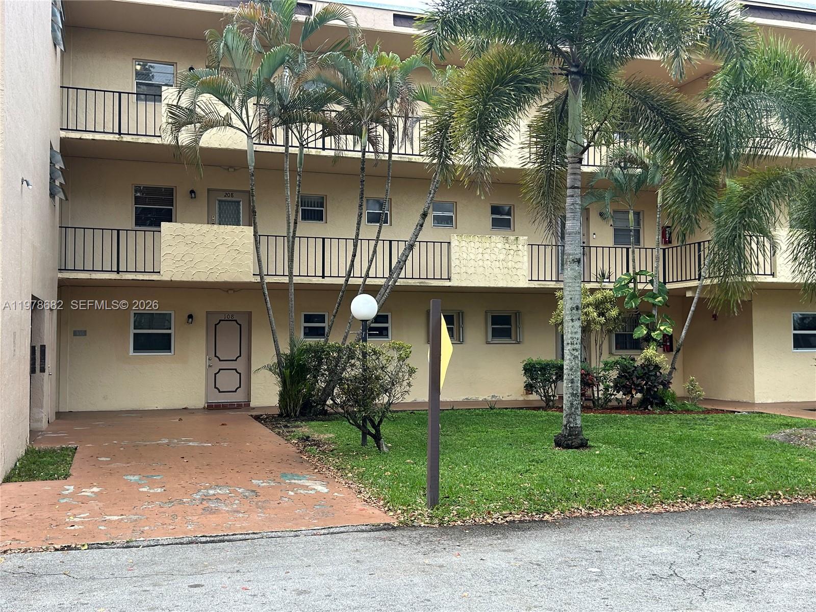 300 Berkley Road, Unit 108 Hollywood, FL 33024 - Photo 2 of 41 a front view of a house with garden