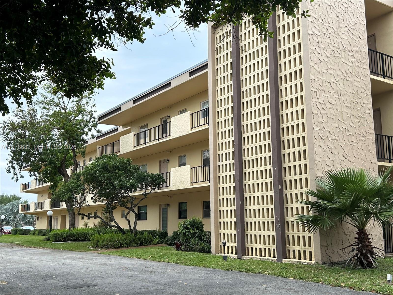 300 Berkley Road, Unit 108 Hollywood, FL 33024 - Photo 27 of 41 a front view of a building with a garden