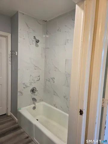 a bathroom with a bathtub and shower