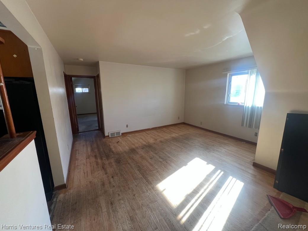 21111-15 Moross Road Grosse Pointe, MI 48236 - Photo 7 of 25 Living room with wood finished floors and baseboards (upper)