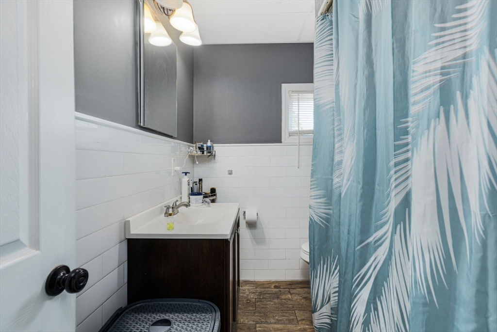 506 Snell Street Fall River, MA 02721 - Photo 22 of 26 a bathroom with a sink and mirror