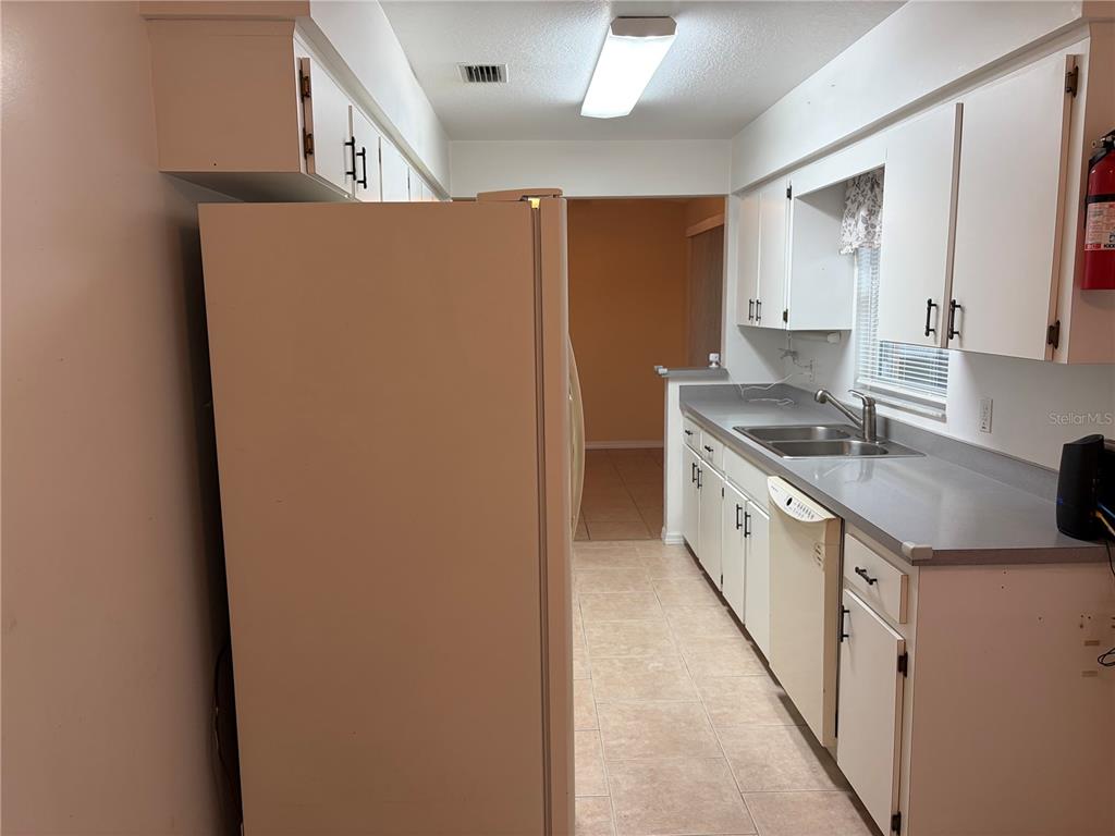 15405 Southwest 43rd Avenue Road Ocala, FL 34473 - Photo 10 of 27 a kitchen with stainless steel appliances granite countertop a sink and a refrigerator