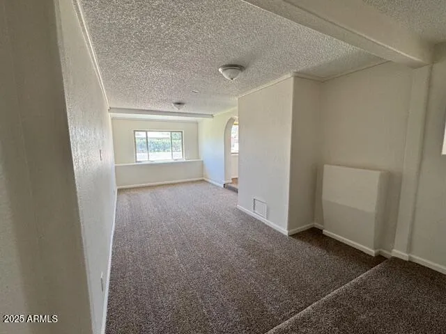 a kitchen with a sink a stove cabinets and a window