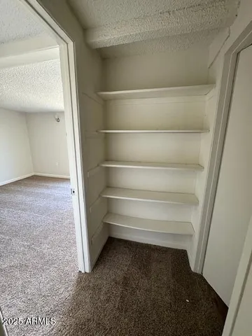 a view of room with stairs and wooden floor