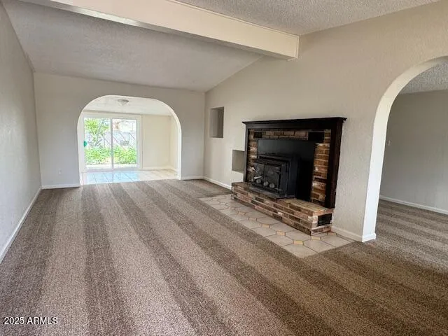 a view of empty room with a fireplace