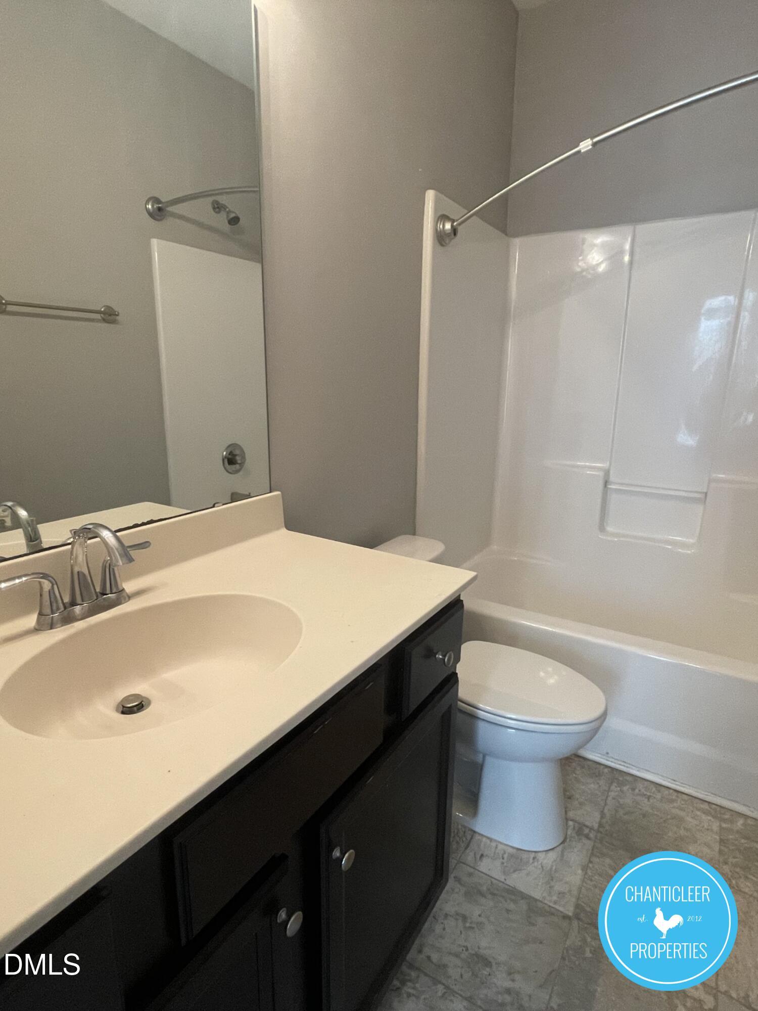 911 Chaney Road, Unit 100 Raleigh, NC 27606 - Photo 16 of 19 a bathroom with a sink and a mirror