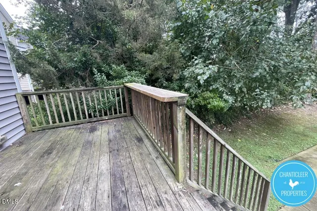 a view of a balcony with wooden floor and fence