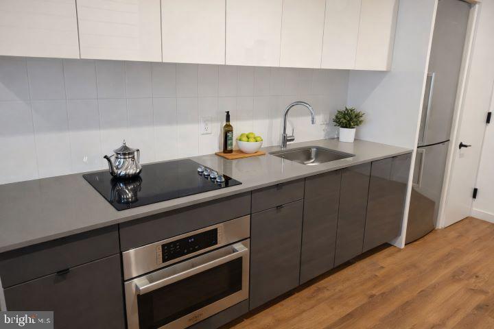 57 N Street Northwest, Unit 331 Washington, DC 20001 - Photo 4 of 18 a kitchen with a sink cabinets and window