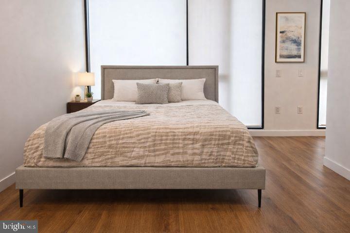 57 N Street Northwest, Unit 331 Washington, DC 20001 - Photo 7 of 18 a bedroom with a bed and wooden floor