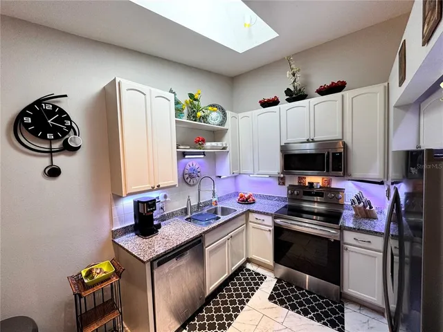 a kitchen with a refrigerator and a stove top oven