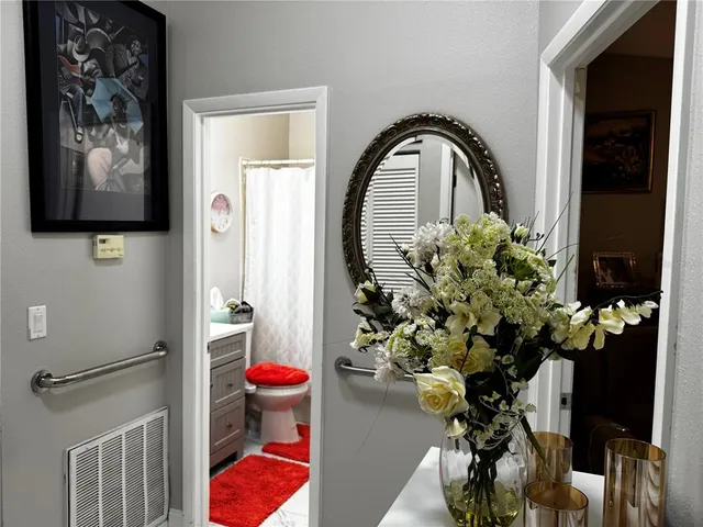 a view of a hallway with paintings on the wall