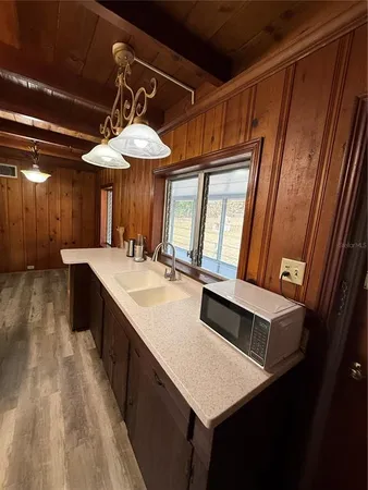 a kitchen with a sink a counter top space and a view of kitchen