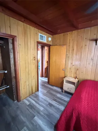a view of a room with wooden floor and windows