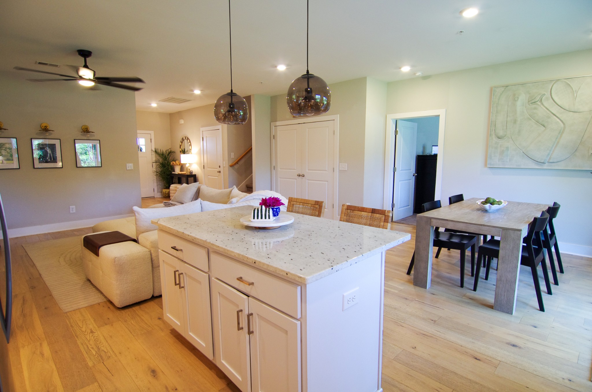 1144 Lock 4 Road, Unit H1 Gallatin, TN 37066 - Photo 3 of 24 a kitchen with kitchen island granite countertop a dining table chairs sink and white cabinets