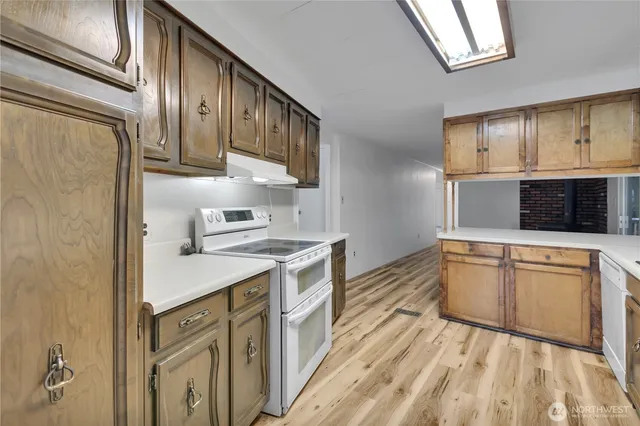 a kitchen with granite countertop cabinets stainless steel appliances and a counter space