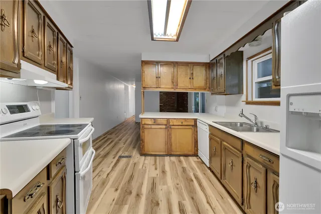 a kitchen with a sink stove and cabinets