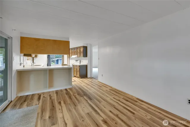 a view of kitchen with wooden floor and electronic appliances