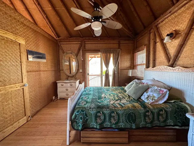 a bedroom with furniture and a large window