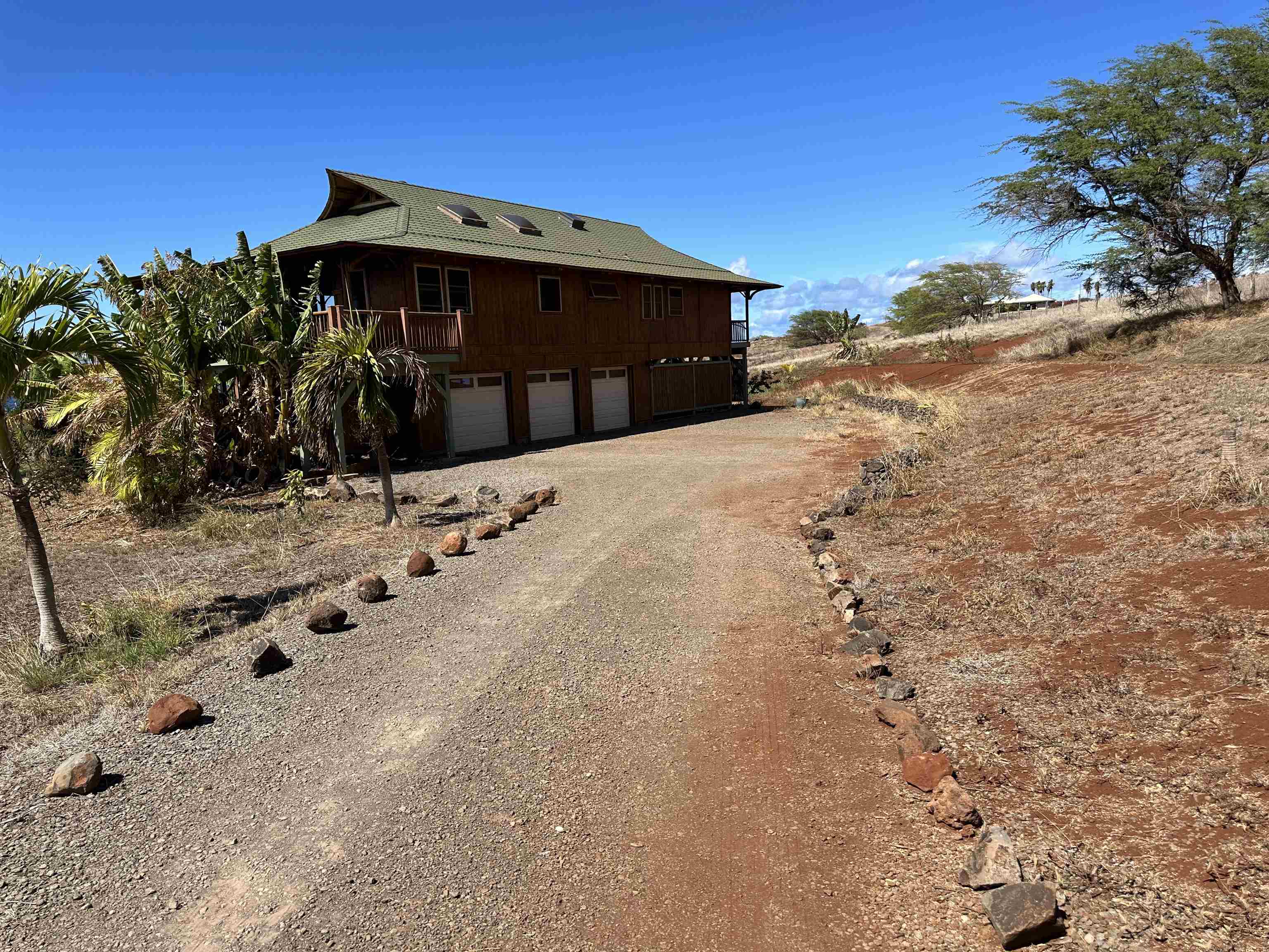 206 Awawa Road Maunaloa, HI 96770 - Photo 22 of 28 a front view of a house with a yard