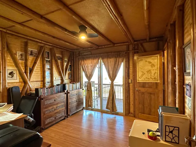 a living room with furniture and large windows