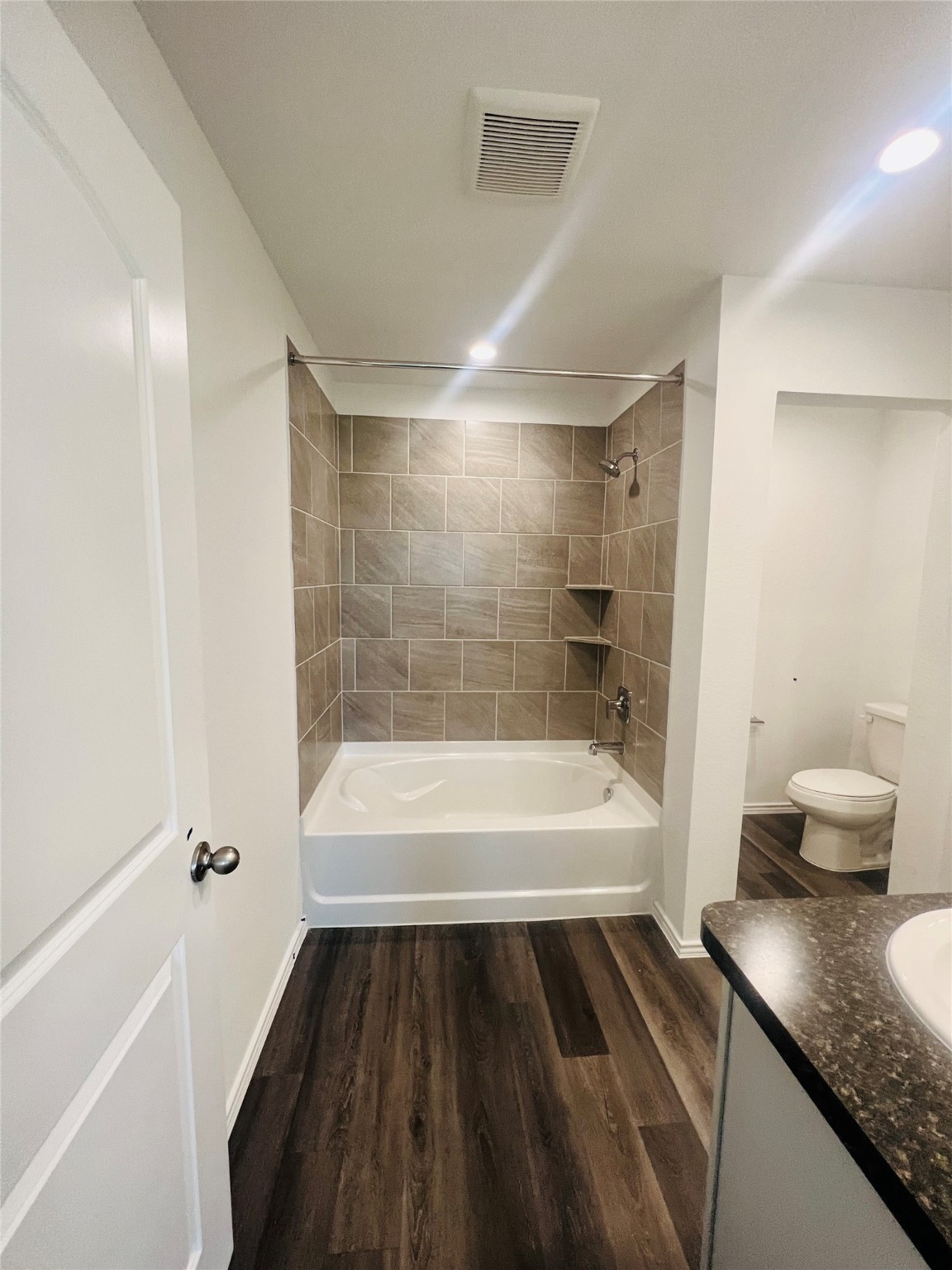 5215 Mossdale Bluff Ln Spring Spring, TX 77373 - Photo 11 of 25 a bathroom with a granite countertop sink a toilet and bathtub