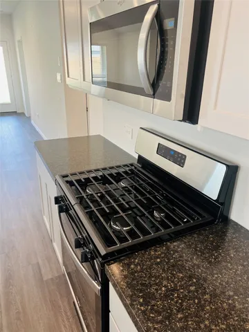 a close view of a stove a microwave and cabinets in the kitchen