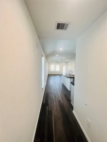 a view of hallway with wooden floor