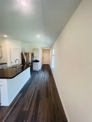 a view of a kitchen with a sink and cabinets