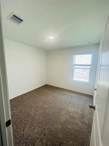 an empty room with a empty space and windows