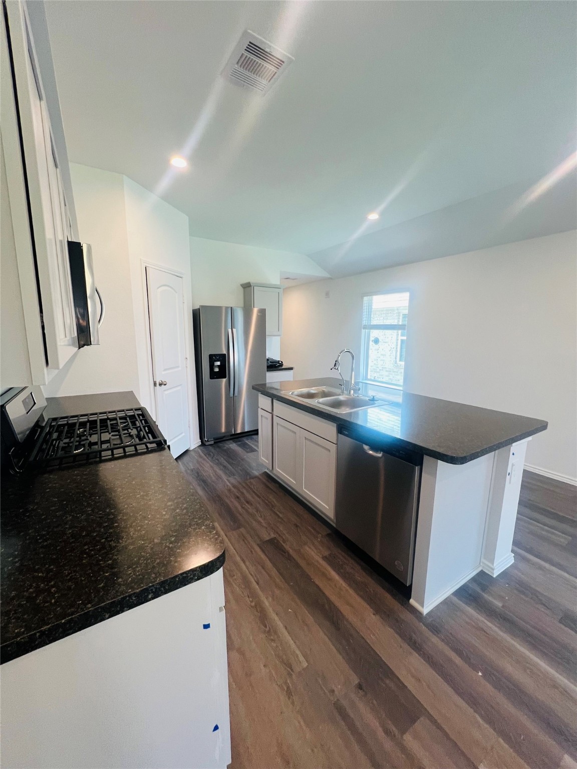 5215 Mossdale Bluff Ln Spring Spring, TX 77373 - Photo 8 of 25 a kitchen with stainless steel appliances granite countertop a stove a sink and a refrigerator