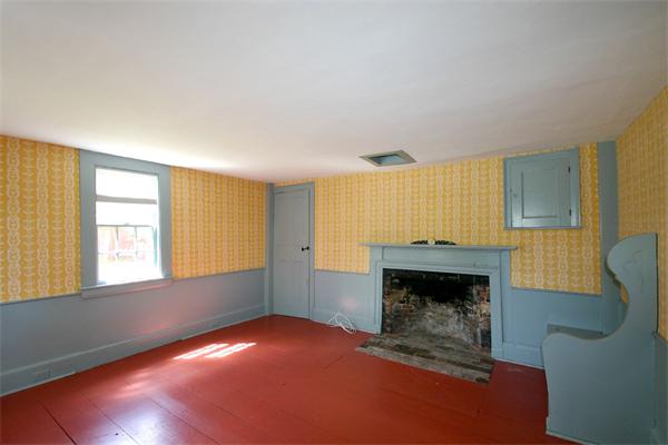 29 River Road Wayland, MA 01778 - Photo 9 of 18 a view of an empty room with a fireplace and a window