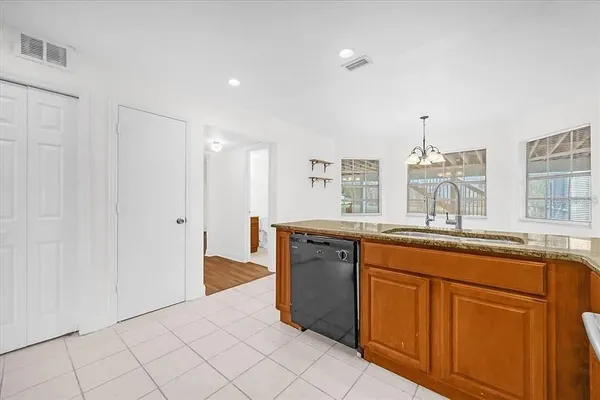 a spacious bathroom with a granite countertop sink and a mirror
