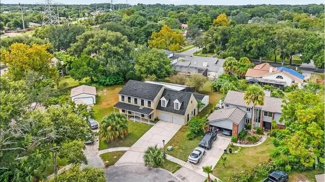 an aerial view of a house with a yard
