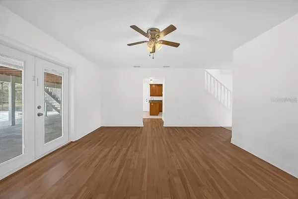 a view of empty room with wooden floor