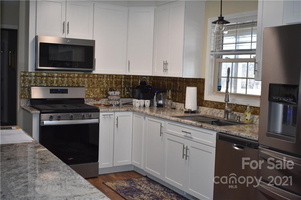 2956 Harmony Road Rock Hill, SC 29730 - Photo 8 of 27 a kitchen with a sink stove and microwave