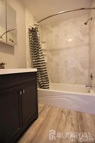 a bathroom with a shower and a sink